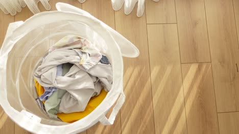 a white laundry basket full of dirty clothes