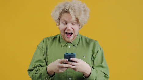 man looking at phone and smiling