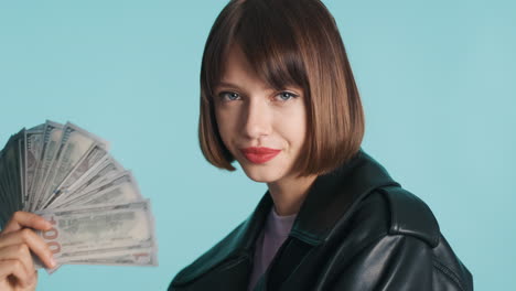 young woman fanning herself with banknotes