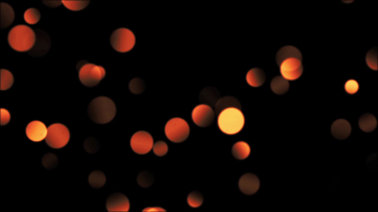 Luci bokeh arancioni astratte fluttuanti su sfondo nero