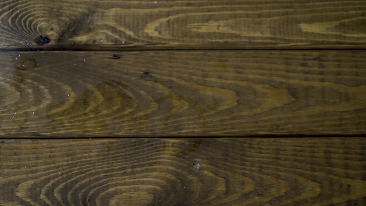 남성 바텐더가 알코올 음료를 제공하고 유리잔에 레몬을 떨어뜨리고, 남성 고객 손은 알코올 술을 마시고 테이블에 다시 놓습니다.