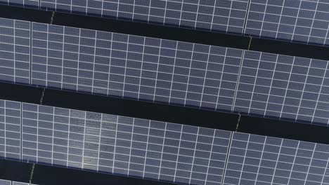 Drone-zooming-out-and-turning-shot-of-rows-of-solar-panels