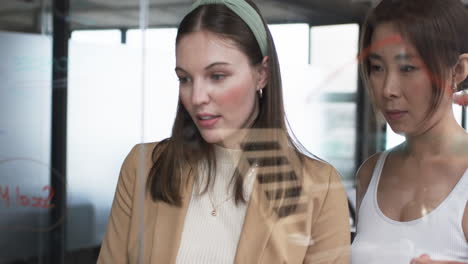 Young-Caucasian-woman-and-Asian-woman-appear-focused-on-task-related-to-their-business