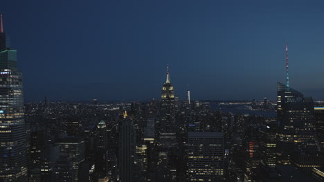 manhattan and the empire state building at night, with illuminations on its top, wide angle and static shot