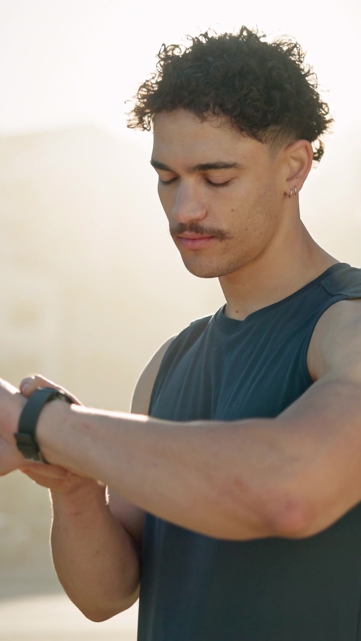 Young Man Checking Smartwatch During Outdoor Workout
