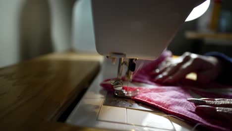 using a sewing machine to stitch together a quilt block - isolated close up