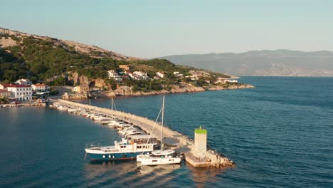 Aerial-shot-looking-across-the-oceanfront-of-a-quiet-village-on-Krk-Island,-Croatia