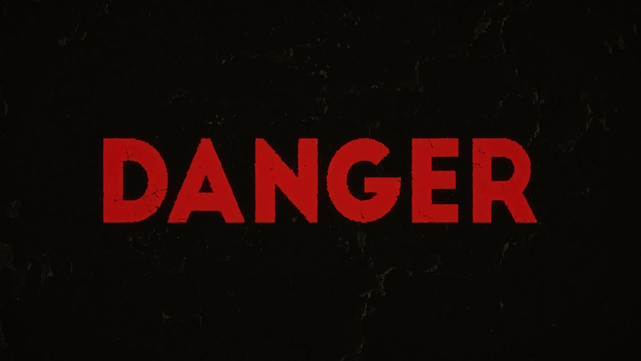Big bold red DANGER flashing text animation, displayed on a gritty black stone background, weathered appearance