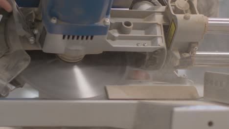 close up shot of a mitre saw cutting a skirting board