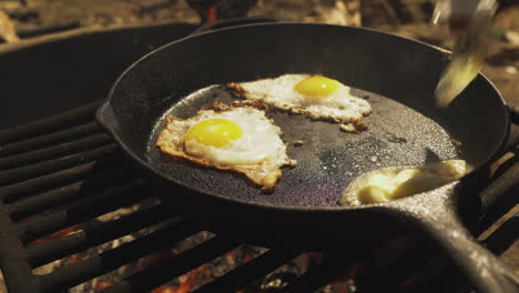 close up cooker melts butter in a frying pan and placing bread on top of it