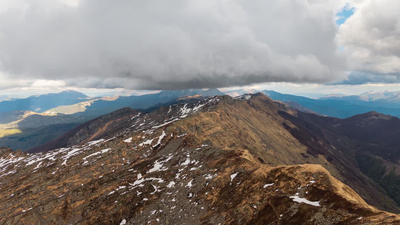 Clouds drifting over the rugged mountain peaks in the Dolomites, Italy during a timelapse