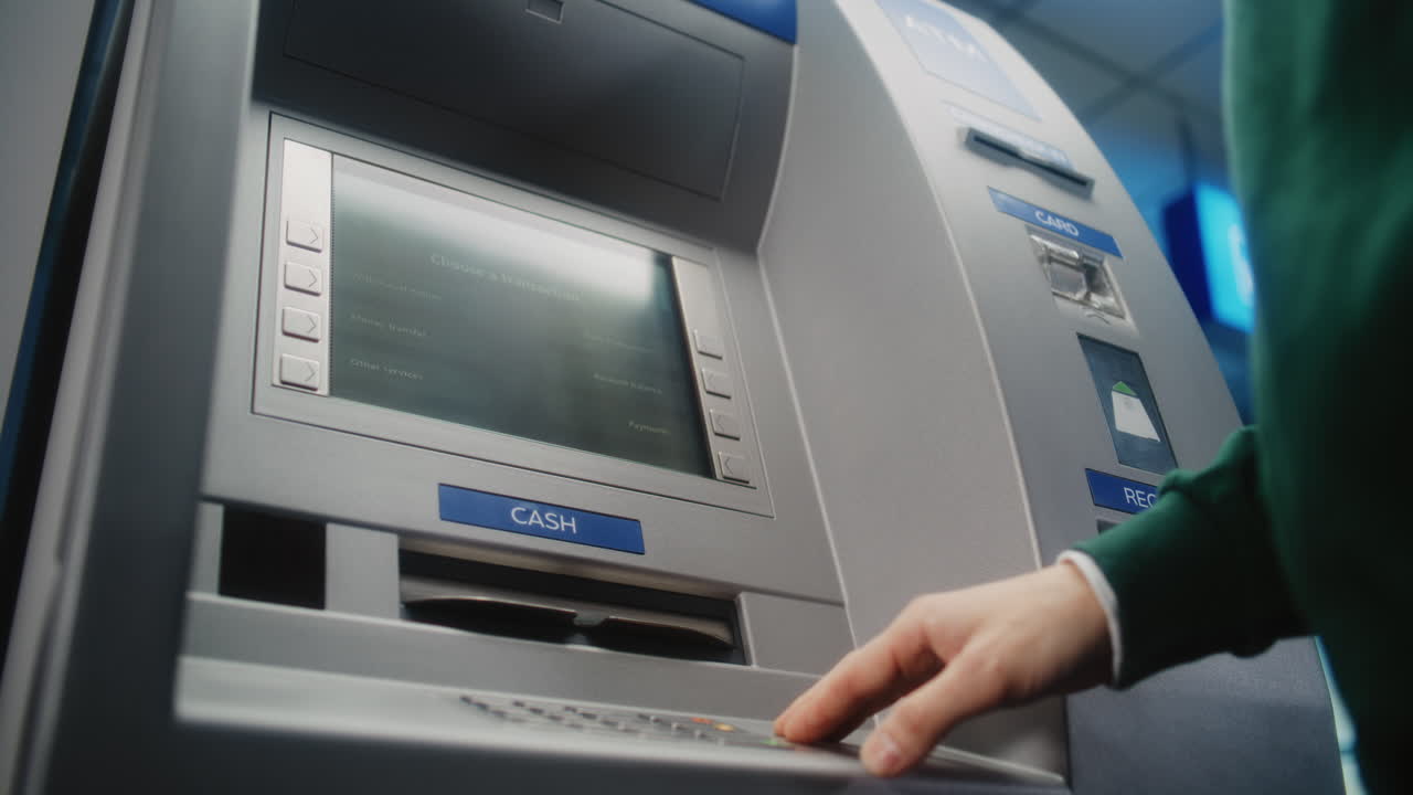Unrecognizable Person Entering PIN Code on ATM Keypad to Withdraw Money. Error Message on Cash Machine Display About Transaction Cancellation Due to Blocked Card. Banking Equipment. Close Up Shot.