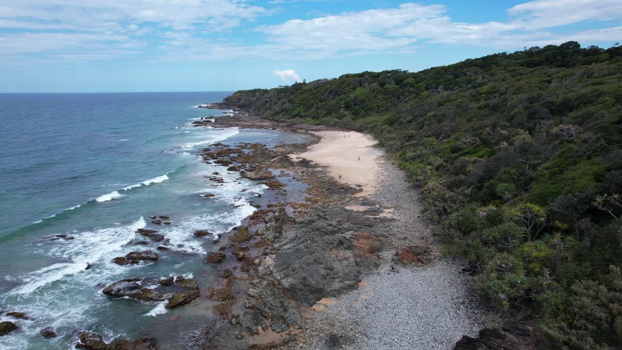 Flying Over Rocky Coastline Along The Forested Hills In Coollum Beach, QLD, Australia. - aerial shot