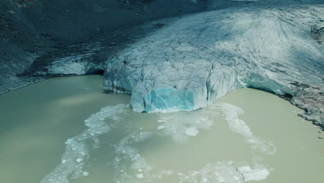 icebergs falling in the water while a glacier is melting due to climate change