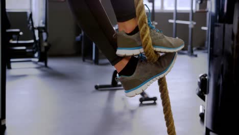 woman exercising with rope in fitness studio 4k