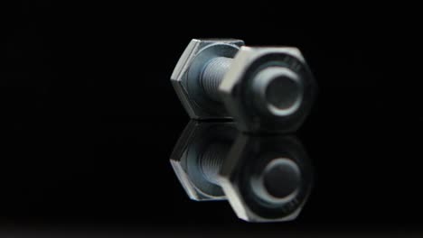 bolt and nut on reflective surface