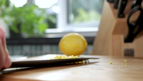 collecting the lemon zest on a knife edge to add to the cooking