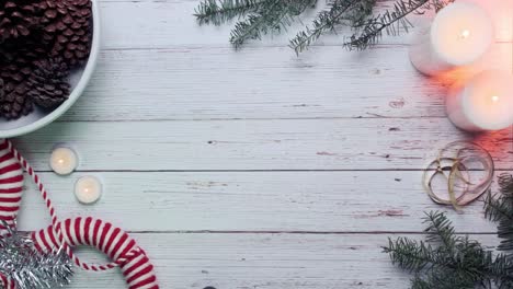 White-wooden-background-with-candles-and-pine-decorations