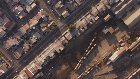 4k aerial drone shot looking down on the city streets in a low-income or suburban neighborhood