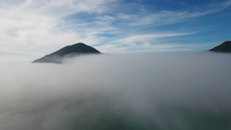 AERIAL:-An-Oregon-mountain-is-revealed-as-a-drone-ascending-through-a-wall-of-fog