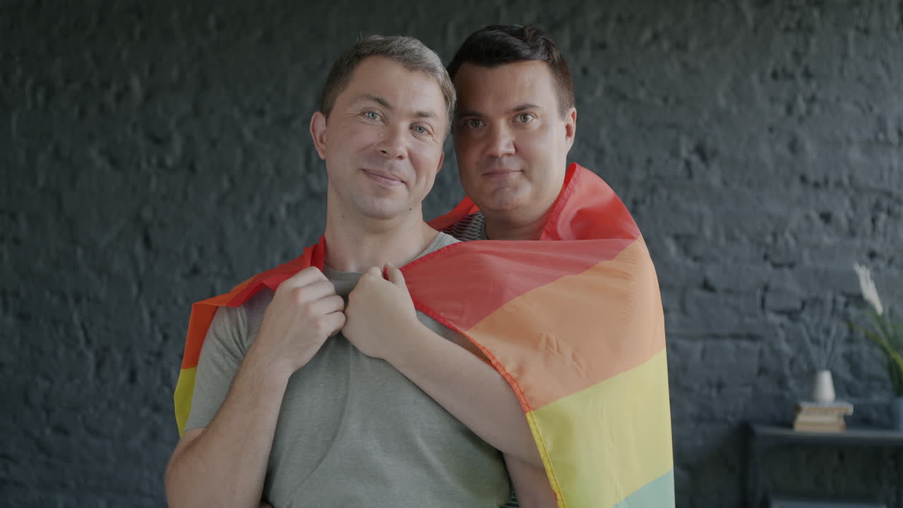 Happy Gay Couple with Pride Flag