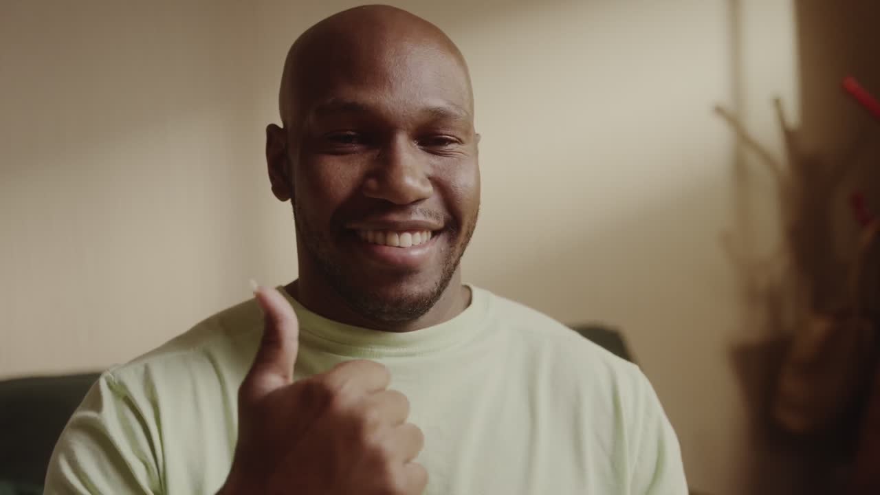 Happy man smiling and giving a thumbs up