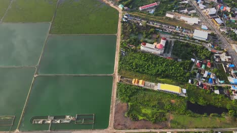 aerial: drone descends over the rectangular drain lakes at sunrise