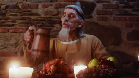 medieval man eating roasted chicken at a feast