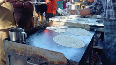 the cook making the masala dosa in the outdoor street food outlet