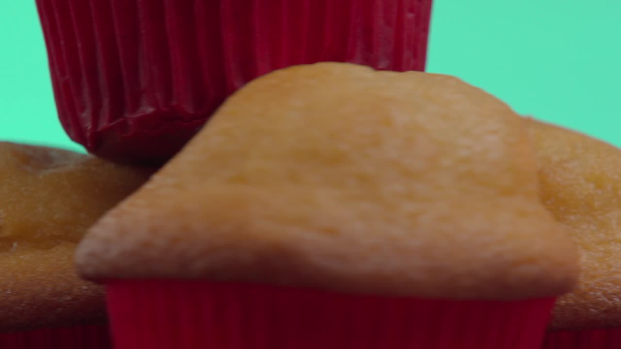 Brown tamales cupcakes rotating with blurred acqua color background, reating a vibrant and inviting culinary scene