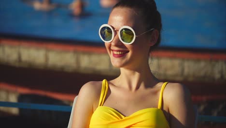 young woman relaxing by the pool