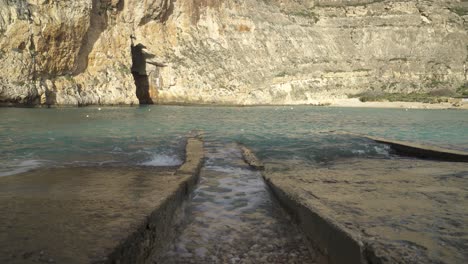 Turquoise-Water-Washes-Rows-made-from-Stone-and-Filled-Pebbles-near-Inland-Sea-Caves-Area-in-Malta