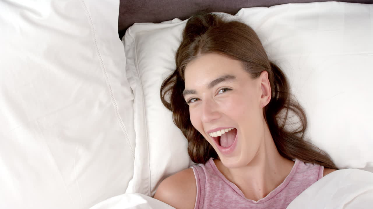 Brown haired girl getting into bed: soft moments in serene repose
