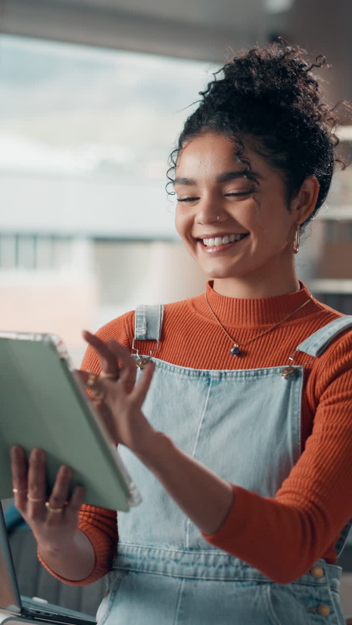 Happy Young Woman Smiling While Using a Digital Tablet