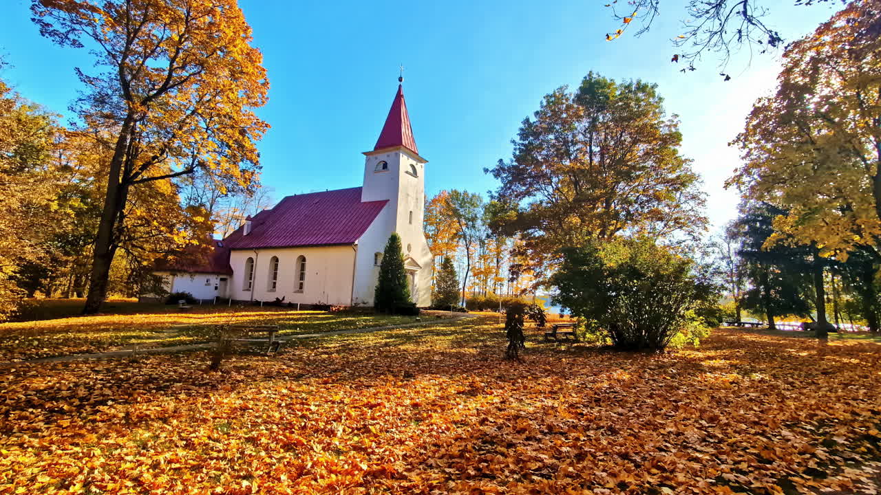 Lielvārde Lutheran Church surrounded by autumn colors in Latvia