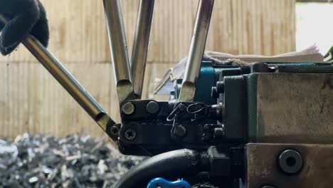 Hand of machine operator is moving the machine lever