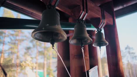 antique bells hanging in a wooden structure