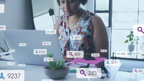 animación de iconos de redes sociales con números sobre mujer afroamericana usando portátil.