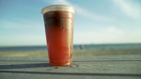Lifestyle-closeup-shot-of-carrot-and-orange-juice-while-sitting-on-a-lifeguard-tower-in-Seal-Beach,-There-is-attention-to-detail-in-this-shot-with-sharp-focus-and-contrast
