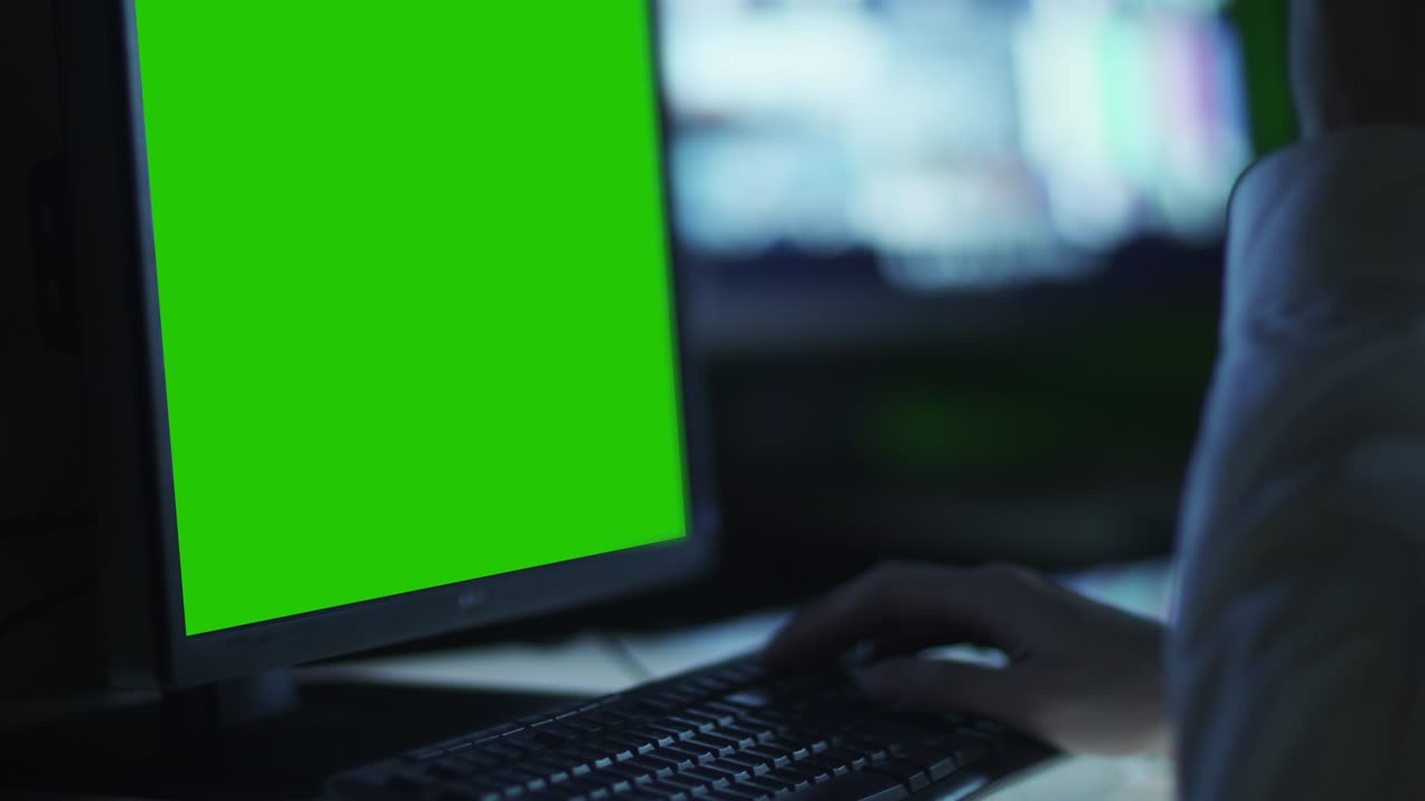 el oficial de seguridad está monitoreando la pantalla con pantalla verde en la sala de control.