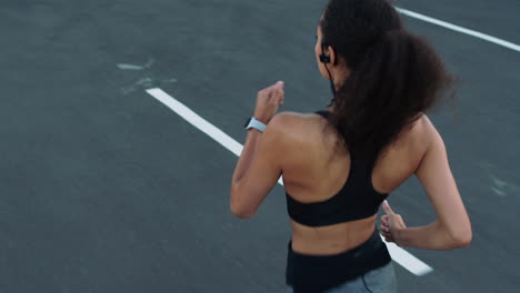 back view, fitness or black woman running on road