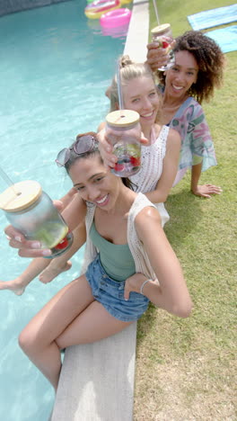 vertical video: a group of friends enjoys drinks by the pool