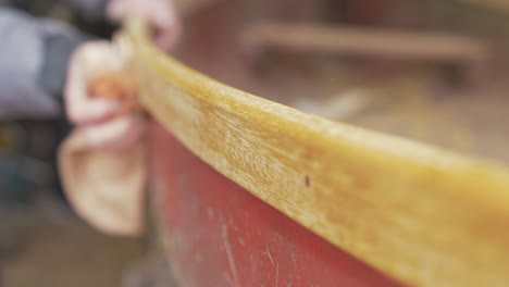 Wiping down boat gunwale with paint thinners on cloth
