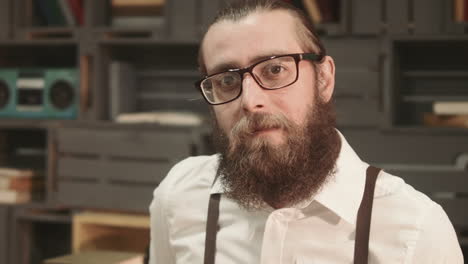 man with beard and glasses in an office setting