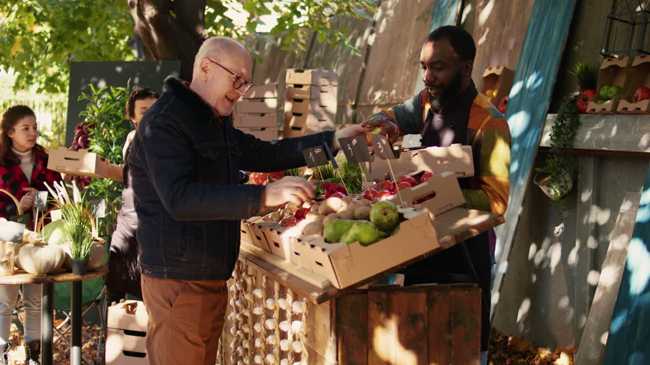 People buying produce at a farmer's market