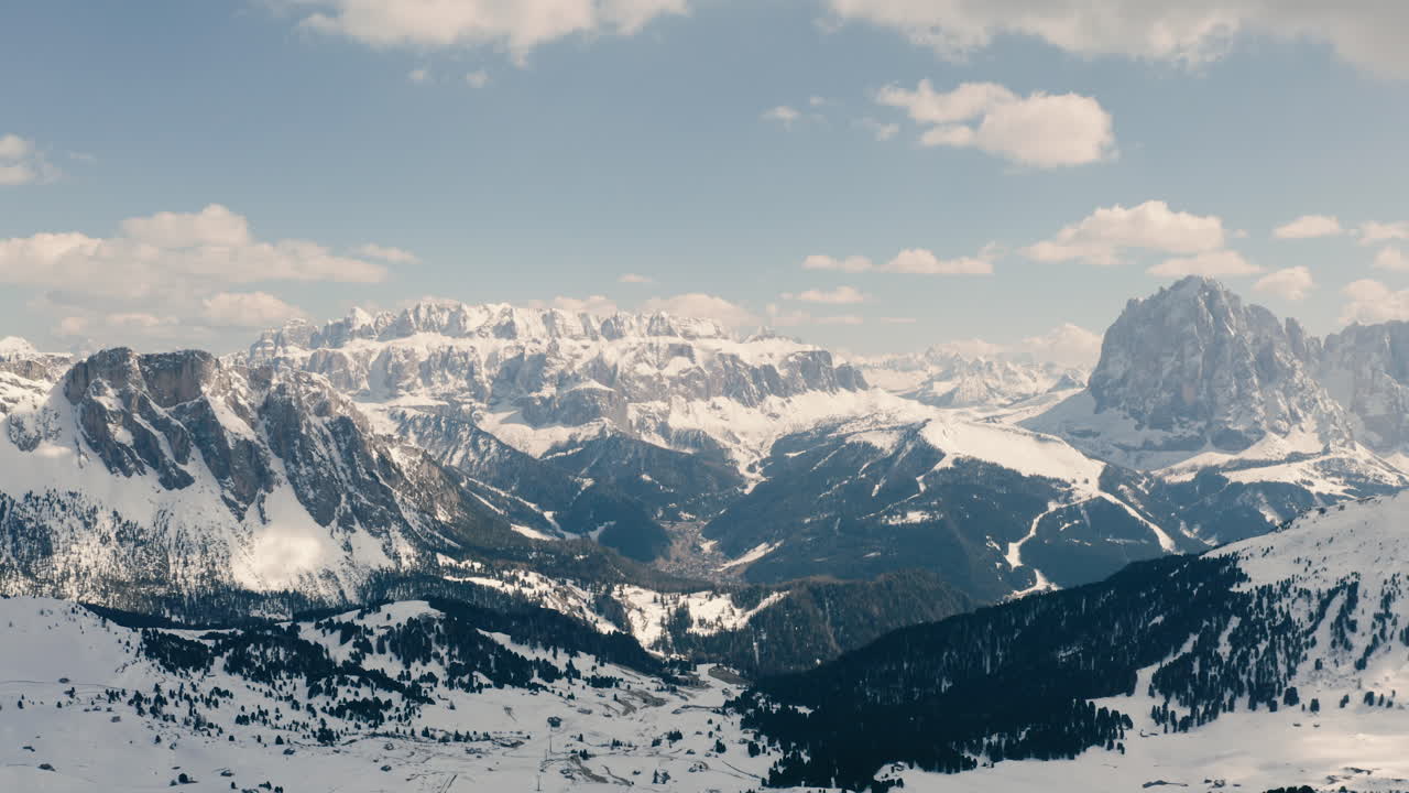 Aerial panoramic view of Dolomites, jagged mountain tops in snow