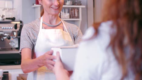 Woman-buying-cake-at-bakery