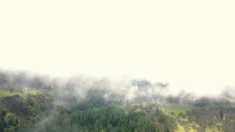 Aerial-footage-of-drone-flying-through-and-emerging-from-clouds-in-the-sky