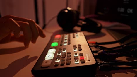 hand operating a video production switcher