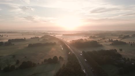 misty sunrise over country road